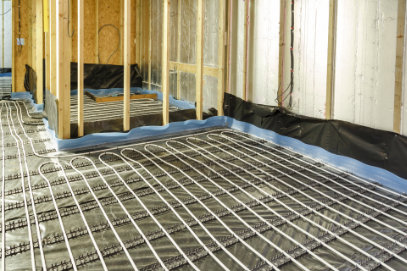 House under construction with underfloor heating water pipes installation to the subfloor