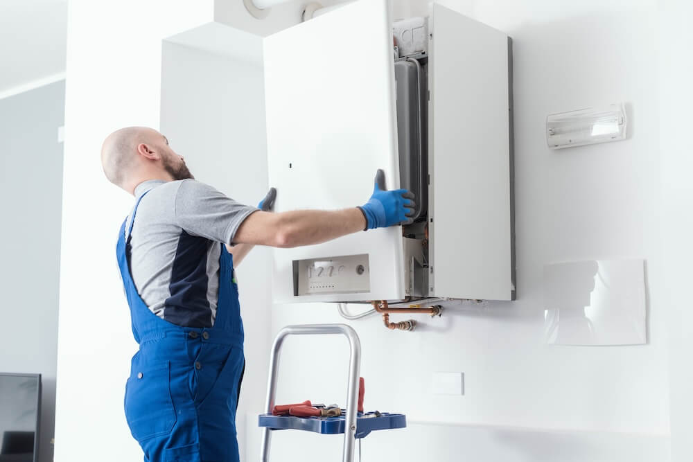 A technican fixing a boiler making banging noise